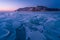 Forzen lake Baikal in winter season at sunrise view from Uzury bay, crack on smooth surface of ice, Siberia, Russia