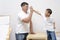 Fother and Son Greets Each Other with High Five Posture