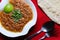 Foul mashes fava beans with lemon and bread served in dish isolated on red mat top view on table arabic food