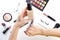 Foundation in woman hands. Professional makeup products with cosmetic beauty products, foundation, lipstick,  eye shadows, eye