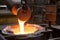 foundry, with close-up of molten metal being poured into mold
