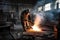 foundry worker, burning out unwanted metal from casting with blowtorch