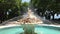 Fountain with angels statue in a sea garden park with grass and trees around it in Varna, Bulgaria