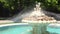 Fountain with angels statue in a sea garden park with grass and trees around it in Varna, Bulgaria