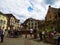 Fountain in the central square of Eguisheim surrounded by typical houses of Alsace
