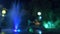 A fountain with colored water lighting, in the evening. close-up, blur, 4k