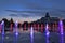 The fountain with colour lights on the main square of Kramatorsk in the summer evening - entertainment not only for children, but