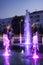 The fountain with colour lights on the main square of Kramatorsk in the summer evening - entertainment not only for children, but