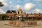 Fountain and courtyard, with blue sky and puffy white clouds,  The Carmel Mission Basilica, the mission of San Carlos Borromeo,