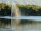 Fountain creating rainbow inside a lake.