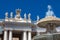 Fountain and detail of the Chigi coats of arms and the statues of saints that crown the colonnades of St. Peter Square built on