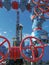 Fountain fittings of a gas well against the background of a drilling rig.