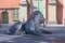 Fountain of the Four Quarters, bronze sculpture of a lion lying on the street, Gdansk, Poland