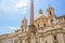 Fountain of the Four Rivers with an Egyptian obelisk and Sant Agnese Church on the famous Piazza Navona Square. Sunny summer day.