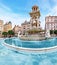 Fountain at Jacobin square with relaxing people and tourists