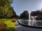 Fountain in lush green and flowered Poznan park