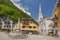 Fountain at Marktplatz, historic town square of Hallstatt with church and traditional colorful houses, Austria.