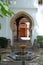 Fountain with Moorish arches to the rear in the Mondragon Palace garden, Ronda, Spain.