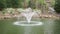 Fountain in the park with Blooming rhododendron flower and white blossom in Noccalula Falls Park in Alabama, USA.