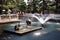 a fountain in the park with feng Shui symbols. A snake lying on a turtle and a crane. Baomo park  Guangzhou China