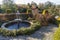 Fountain in park with topiary and stone pavement