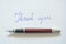 Fountain pen and thank you word on white background