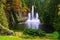 Fountain by pine forest