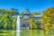 Fountain in a pond in front of the crystal palace at the Parque del Buen Retiro in Madrid, Spain