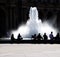 Fountain and resting people silhouettes