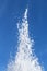 Fountain splashes on blue sky background