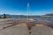 Fountain spraying the ground with a jet of water on the promenade of Lake Chapala