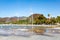 Fountain spraying the ground with jets of water on the promenade of Lake Chapalah the town in the background, sunny day with a