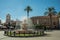 Fountain on a square in front of buildings at Merida