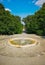 Fountain square with long pathway with concrete pavement