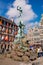 Fountain statue of Brabo throwing the severed hand of Antigoon into the Scheldt river with belfry of the Cathedral of our Lady,