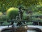 Fountain with two statues in Central Park surround by a garden