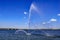 Fountain White Swan in Dnieper river against the background of the Central Bridge in Dnipro Ukraine on a sunny summer day. White