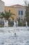 Fountains on the background of a stone residential building