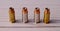 Four 40 caliber hollow point lined up on a white wooden back ground