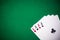 Four aces folded on green casino table, copy space