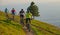Four active friends riding their electric bikes down a narrow mountain trail.