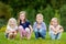 Four adorable little kids outdoors at summer day