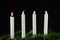 Four advent candles at black background