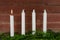 Four advent candles at an old plank wall