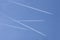 Four aircrafts in the ski make a graphic sign with condensation trails with copy space for your text