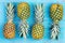 Four alternating pineapples on market table