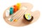 Four art paint brushes with poly acrylic paint in white, yellow, orange and aqua blue colors and partly painted decorative egg in