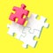 Four assembling puzzle pieces on yellow background