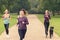 Four Athletic Girls Jog at the Park