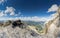 Four attractive women mountain climbers hug and smile on a mountain peak after a hard climb together